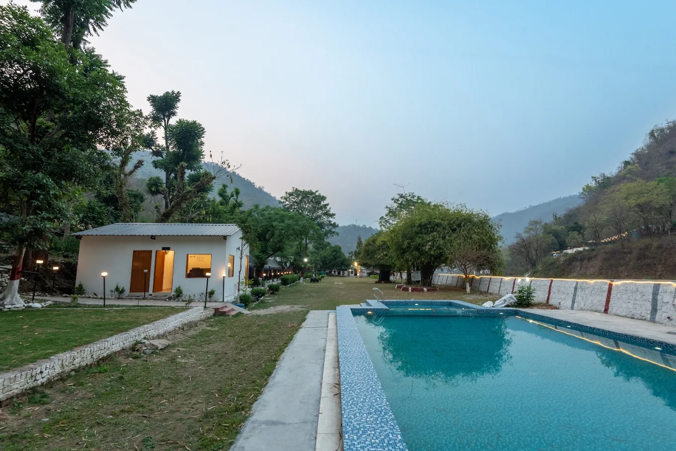 Sunset Resort pool and grounds surrounded by Himalayan hills, Tapovan Rishikesh